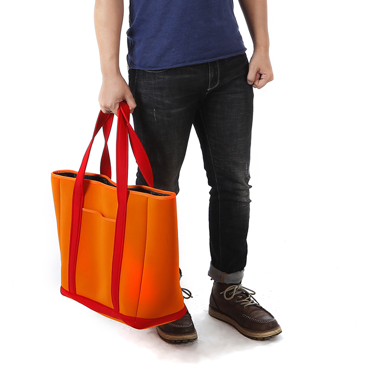 Man holding Orange Neoprene Tote Bag - Spacious Beach and Gym Bag